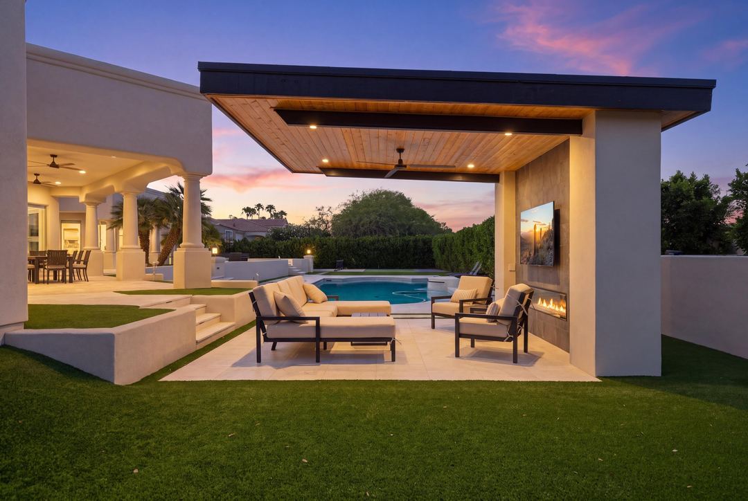 Modern cabana with a fireplace and TV beside the pool at dusk
