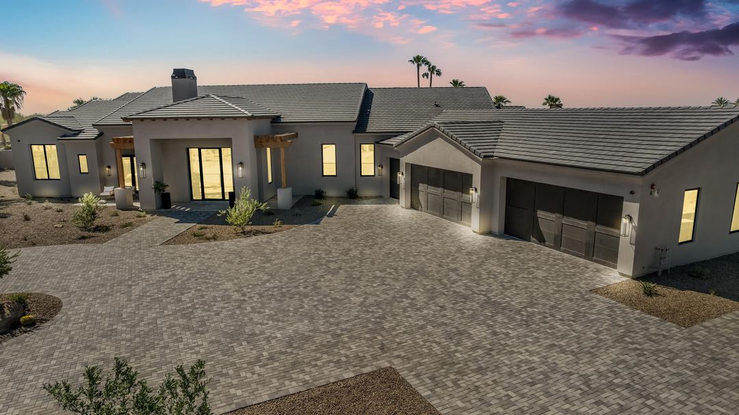 Low aerial of the home and its garages at dusk