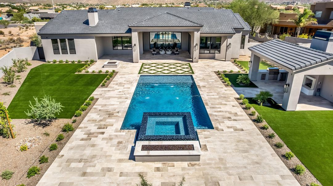 Aerial straight down a long pool and spa to the covered patio