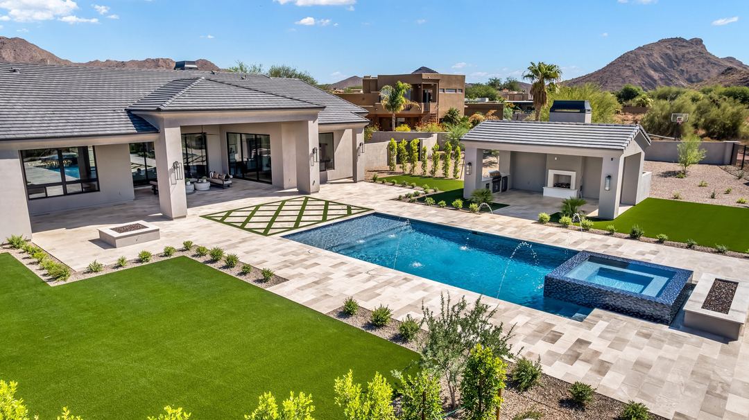 Backyard pool and lawn with the mountains beyond