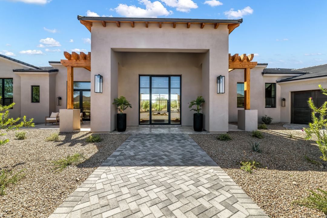 Modern entry with a glass front door and cedar pergolas