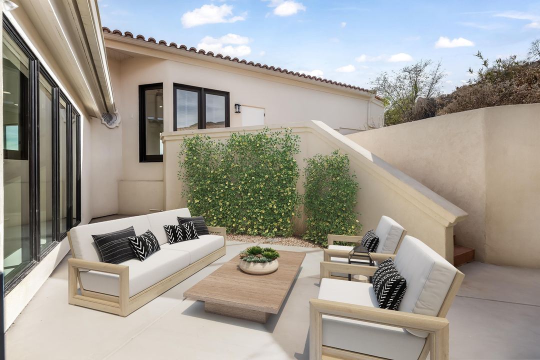 Walled courtyard with outdoor sofas and a living green wall, virtually staged