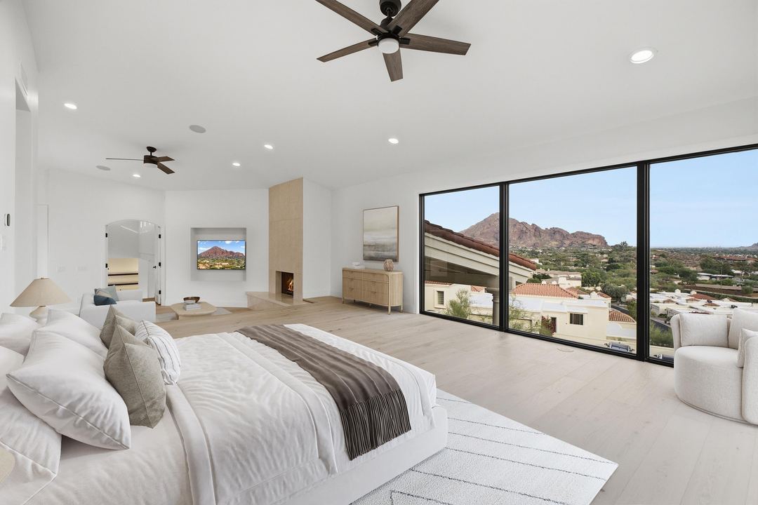Primary suite with corner glass looking out to Camelback Mountain, virtually staged