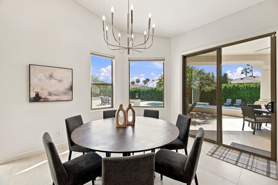 Dining nook with a round table and sliding doors to the pool