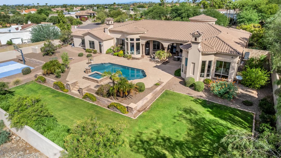 Aerial of a Paradise Valley estate, its pool and grounds, with the mountains behind