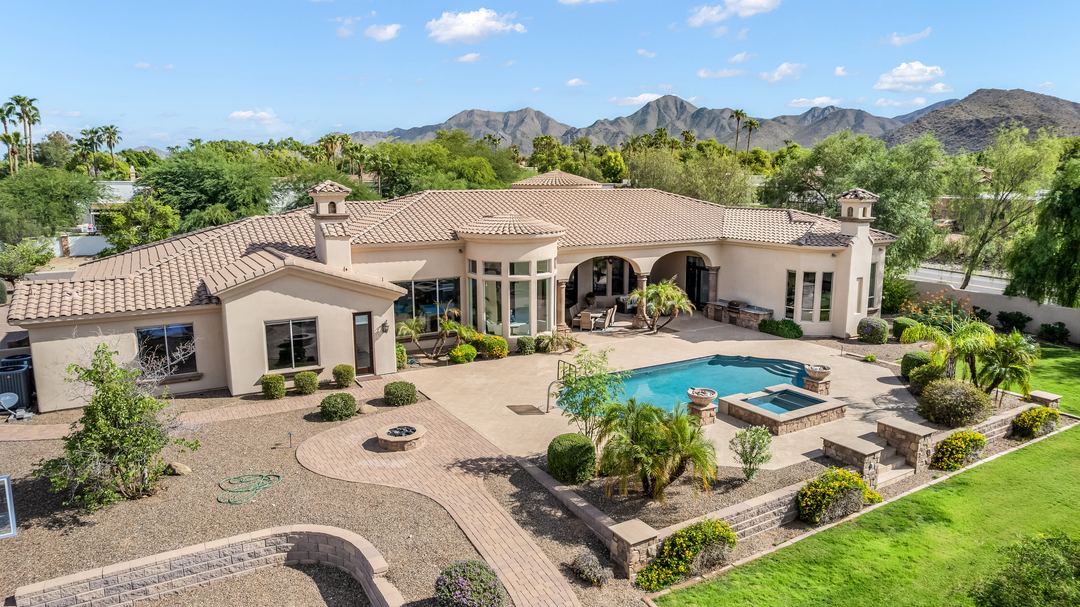 Aerial of a Paradise Valley estate with a pool and Camelback Mountain behind