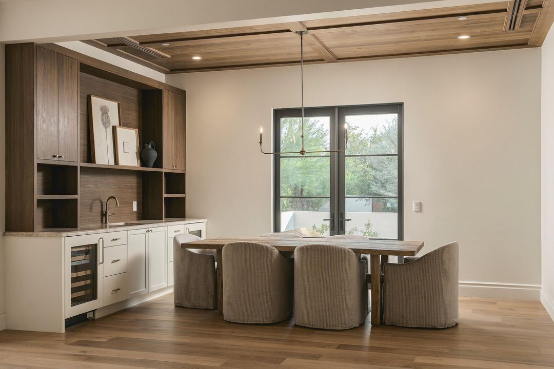 Wet bar with walnut shelves, a wine fridge and a round table