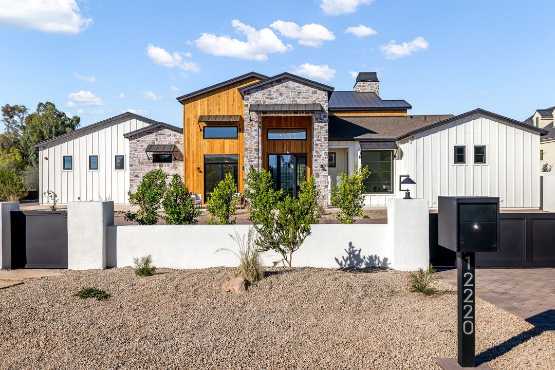 Front of a modern farmhouse with stone and board-and-batten siding