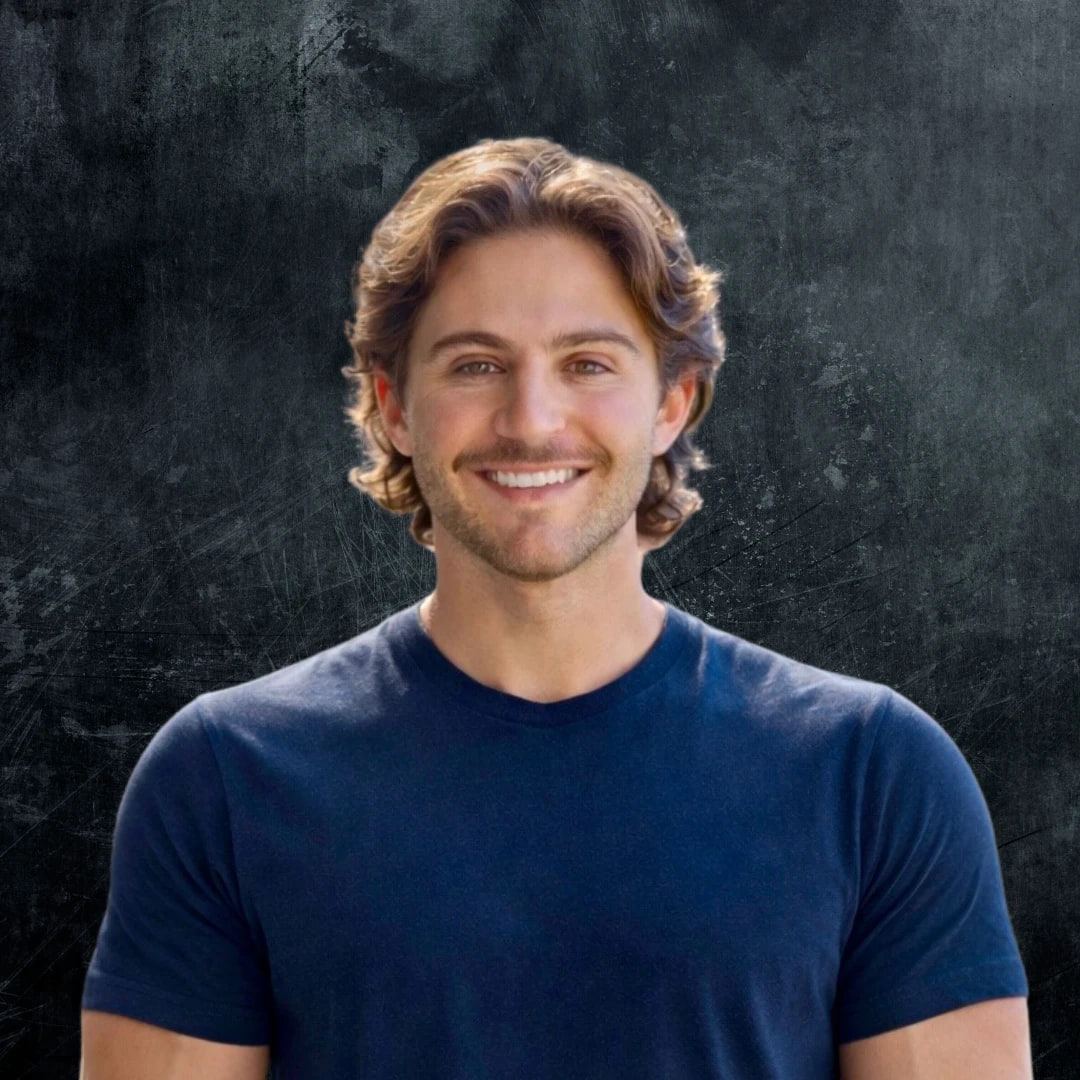 Jake Feingold, owner of Real Estate Photographers, smiling in a navy t-shirt