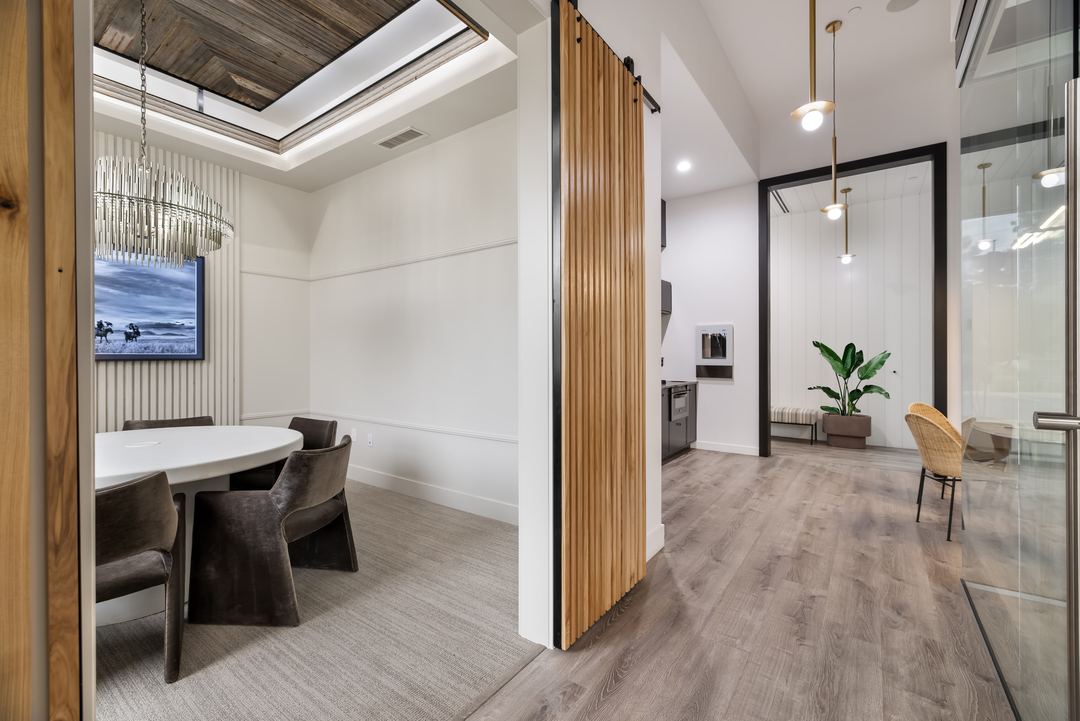 Glass-walled meeting room with oak slat panels