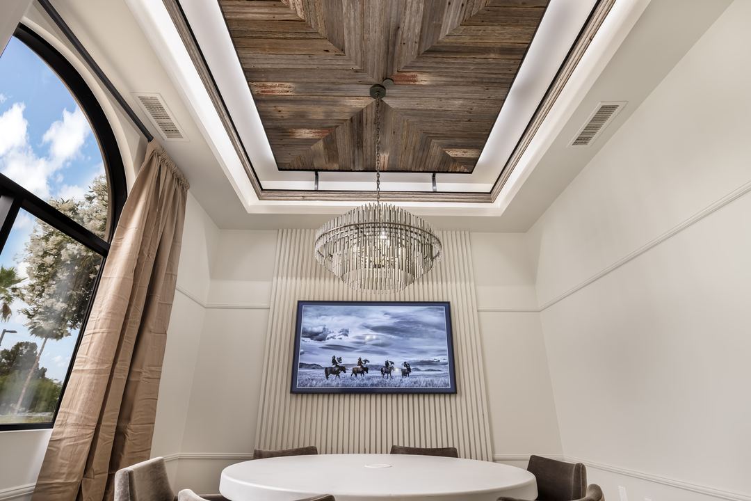 Meeting room with a wood-lined skylight and a round table