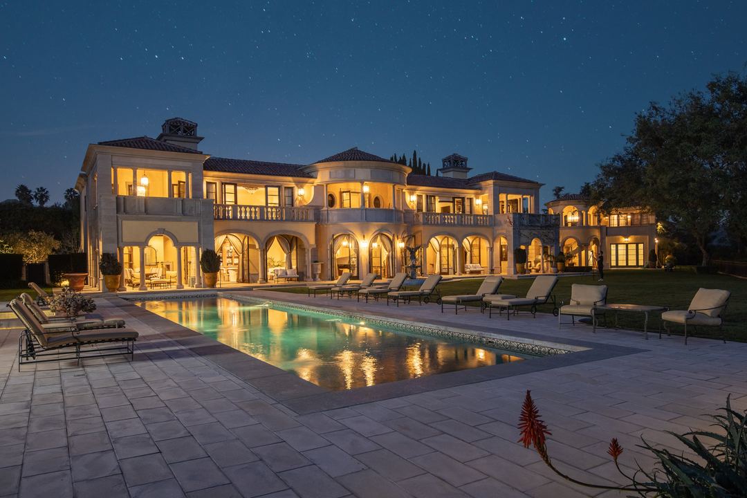 Estate at night, reflected in the pool