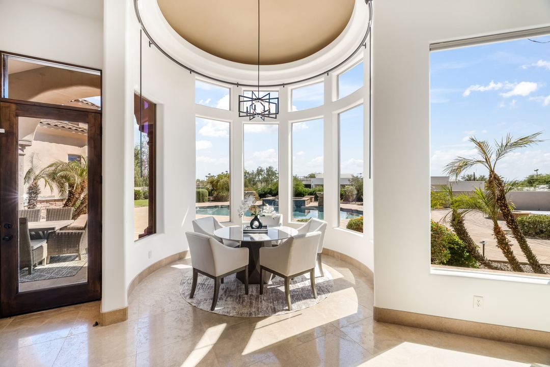 Round breakfast nook with curved windows looking out to the pool