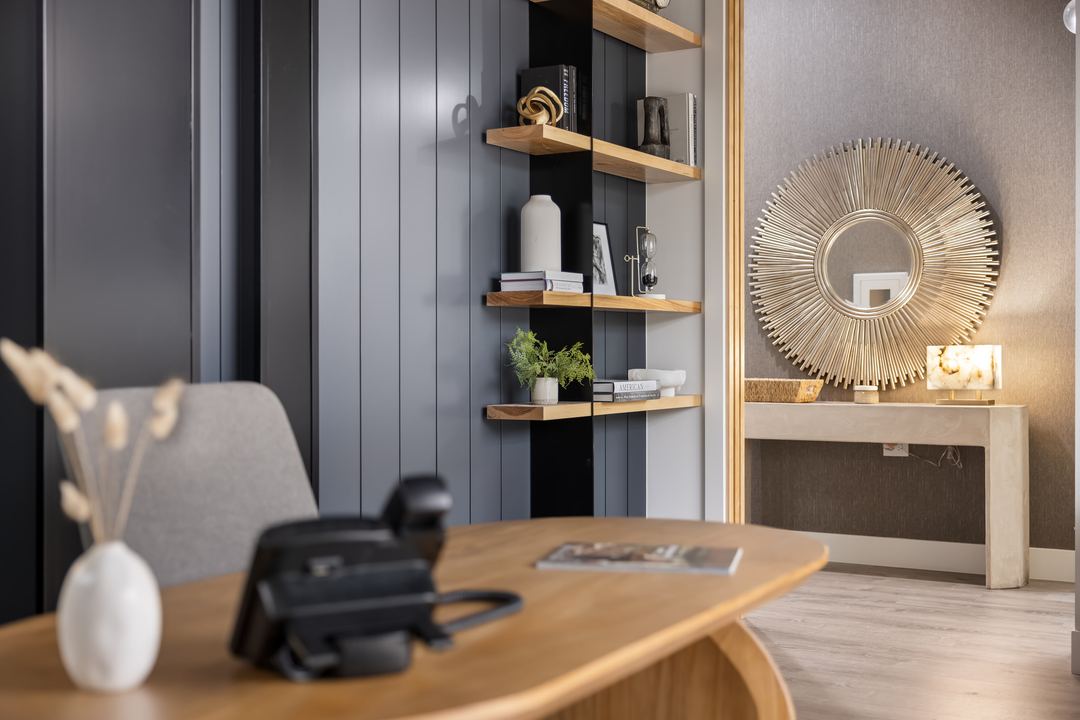 Office with navy shiplap walls, oak shelving and a sunburst mirror