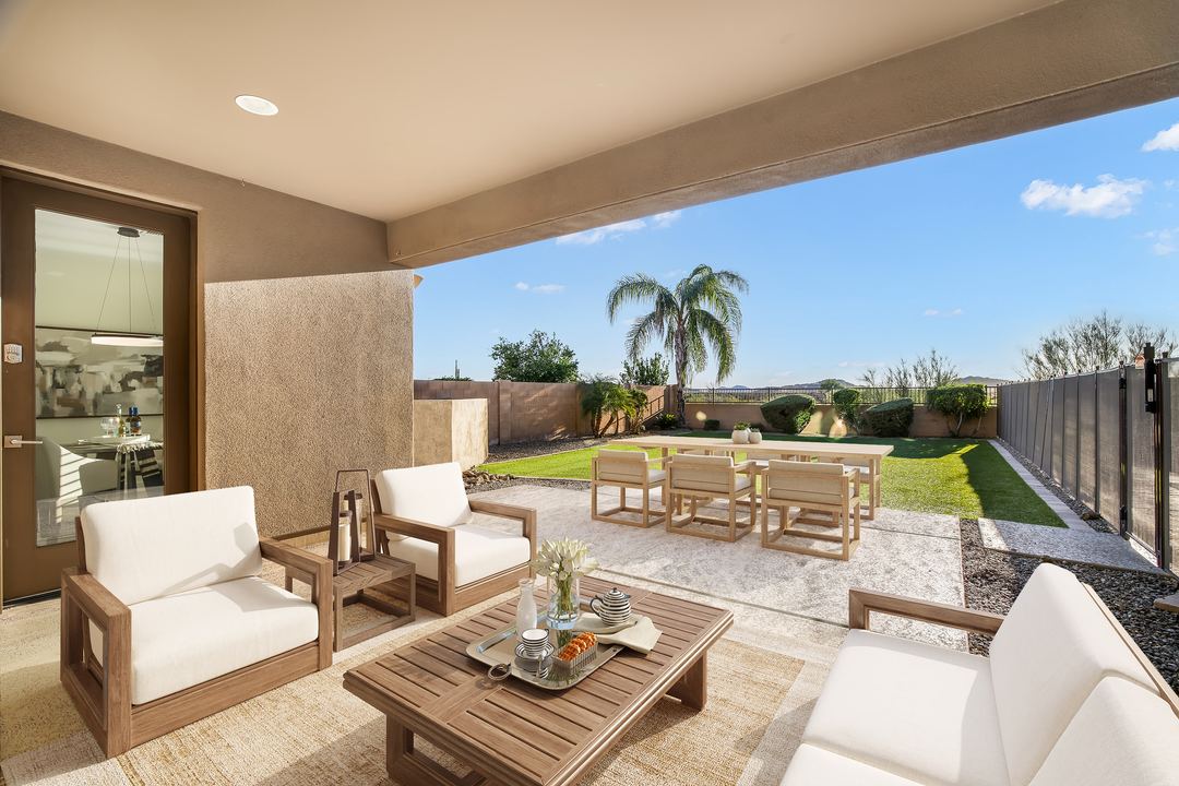 Covered patio virtually staged with outdoor seating and a dining table
