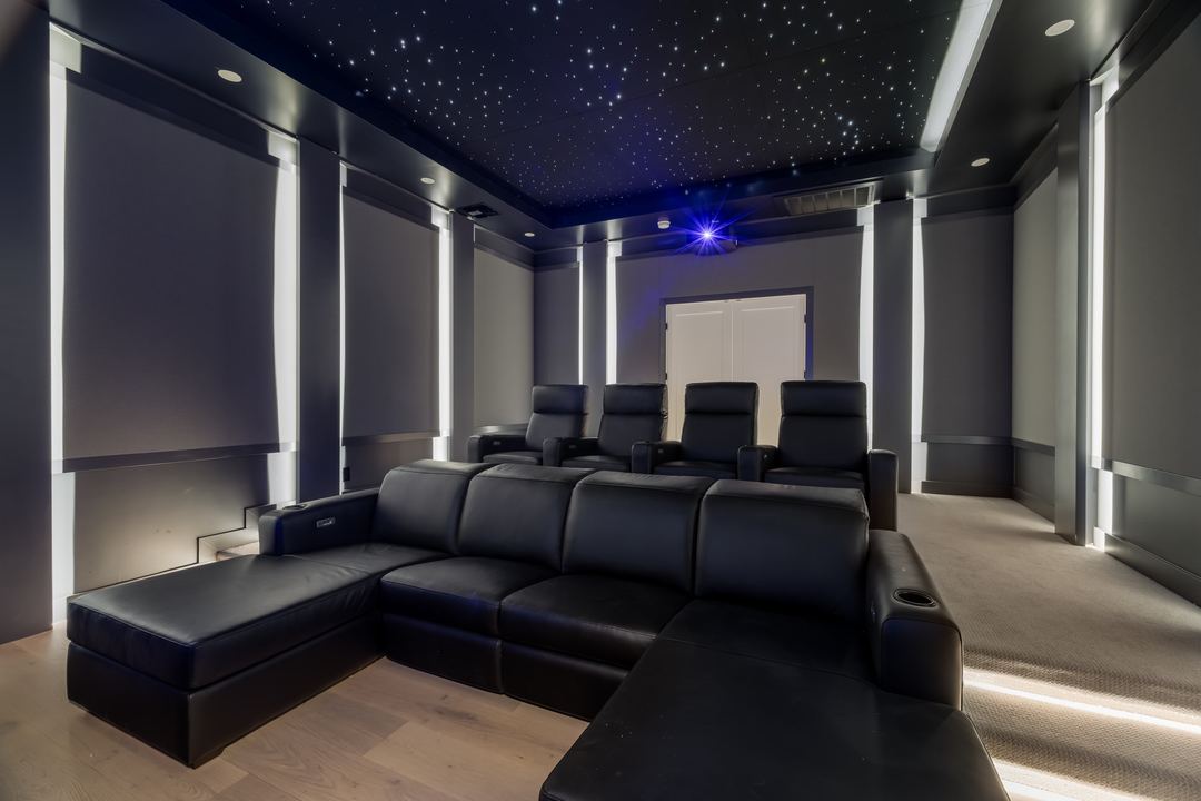 Home theater with black recliners and a star-lit ceiling