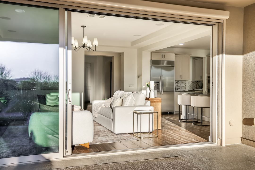 Living room seen through open sliding doors from the patio