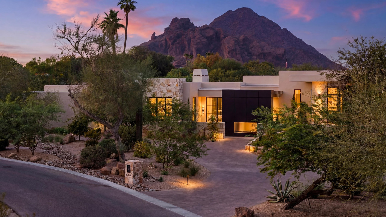 Front of a home below Camelback Mountain, in daylight and as a virtual twilight: virtual twilight