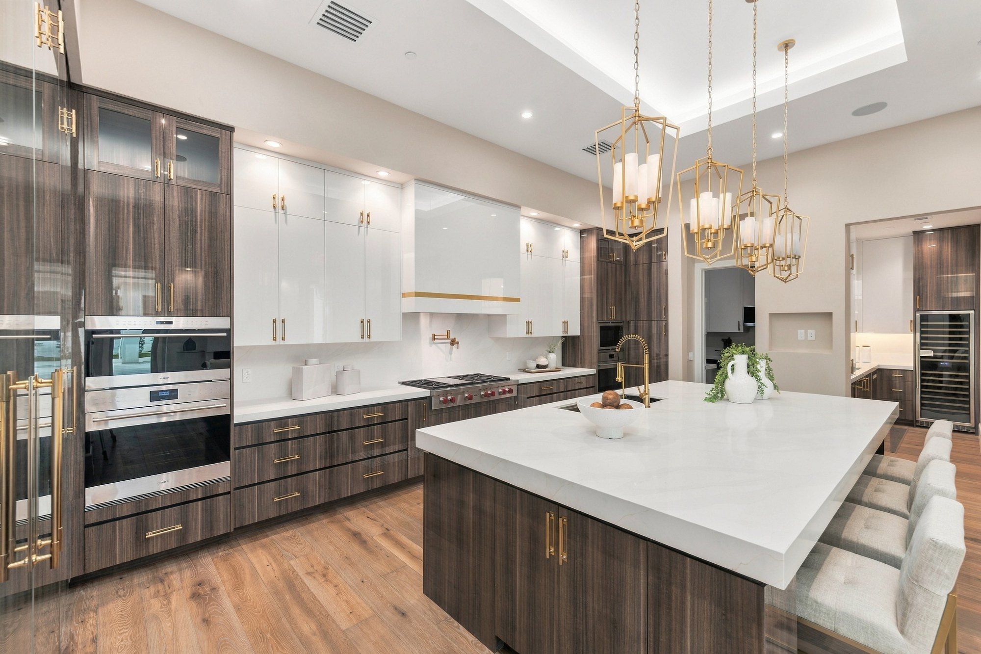 Kitchen with a marble island and walnut cabinets