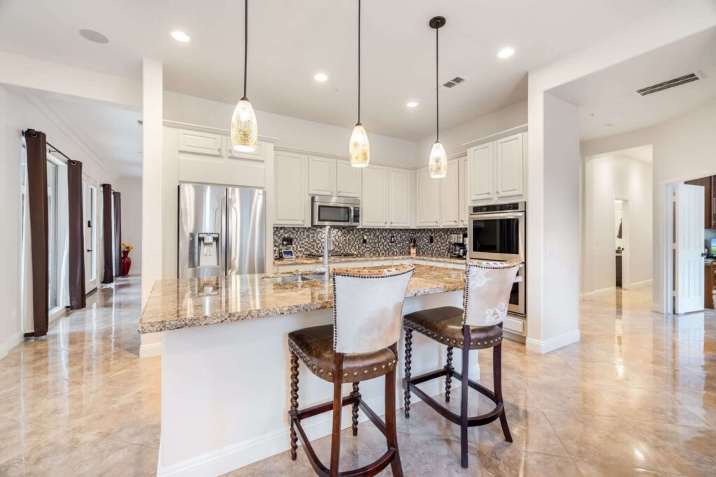 Real estate 3D virtual tour image showing a white kitchen with granite island countertops in Phoenix, AZ