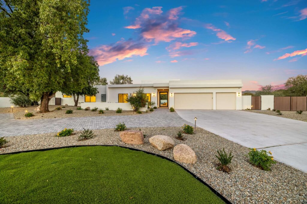Twilight front exterior photography of white home for sale in Mesa, AZ