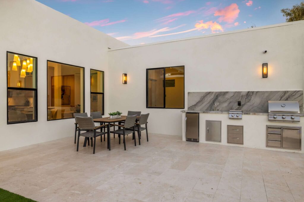 Real Estate Drone Aerial Services in Scottsdale, AZ 3 Real estate photography in Scottsdale AZ showing an outdoor dining patio with built-in stainless steel BBQ kitchen at dusk