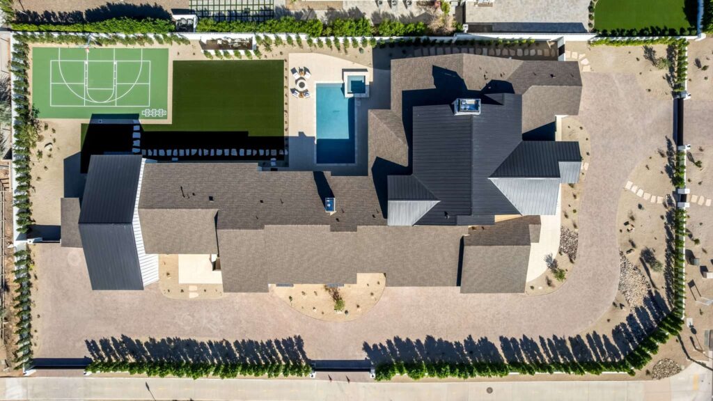 Real Estate Videography Services in Phoenix, AZ 4 Overhead drone aerial real estate photography of a luxury estate with a pool and sports court in Phoenix, AZ