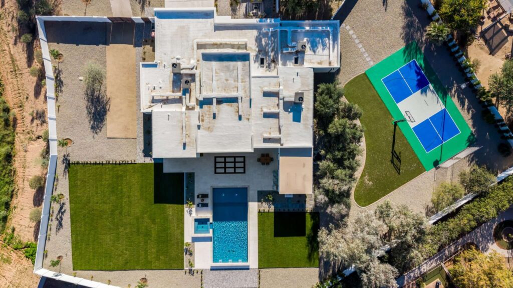 Top down aerial view of pool and sport court estate in Mesa, AZ
