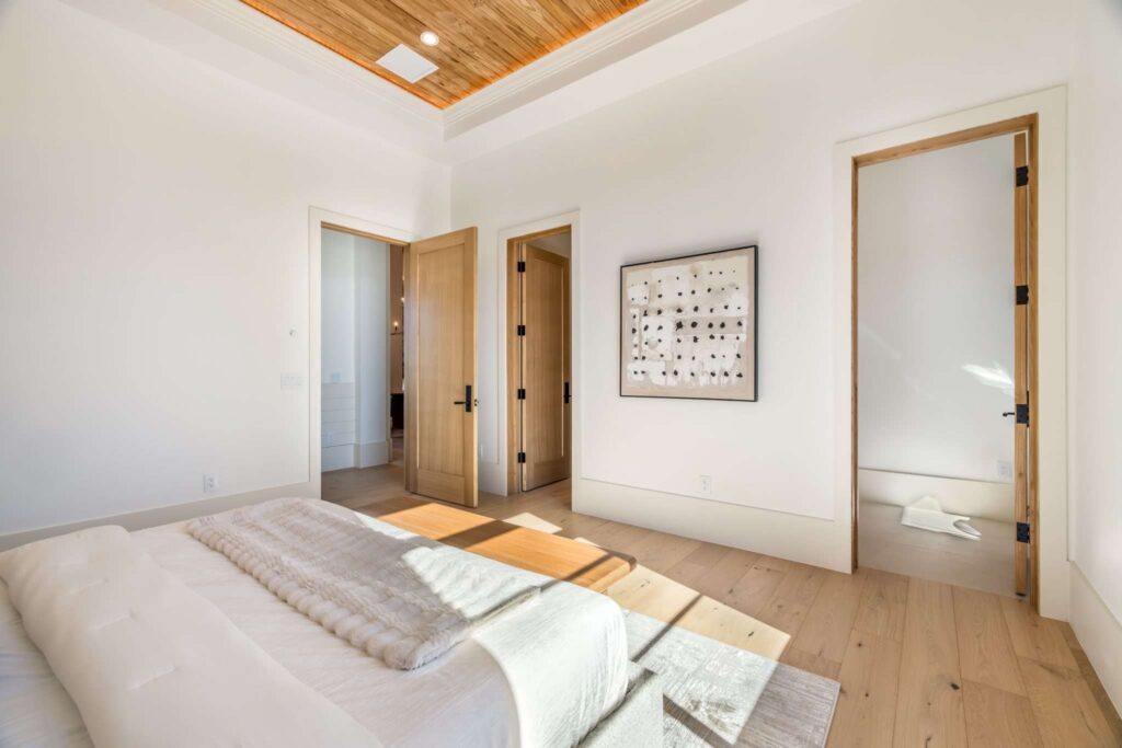 Real Estate Drone Aerial Services in Scottsdale, AZ 1 Real estate photography in Scottsdale AZ showcasing a modern luxury primary bedroom with light wood flooring and wood-paneled ceiling accent