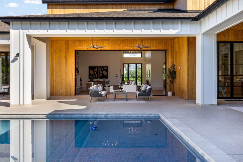 Real estate videography frame capturing a covered patio poolside lounge in Phoenix, AZ