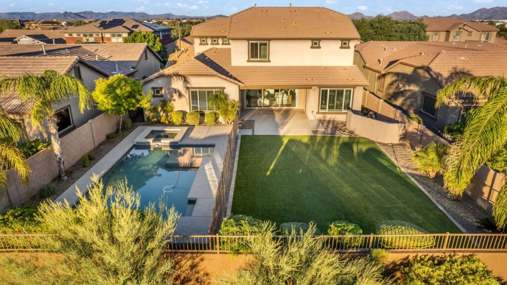 Aerial sunset shot of backyard pool and lawn for a Mesa, AZ listing